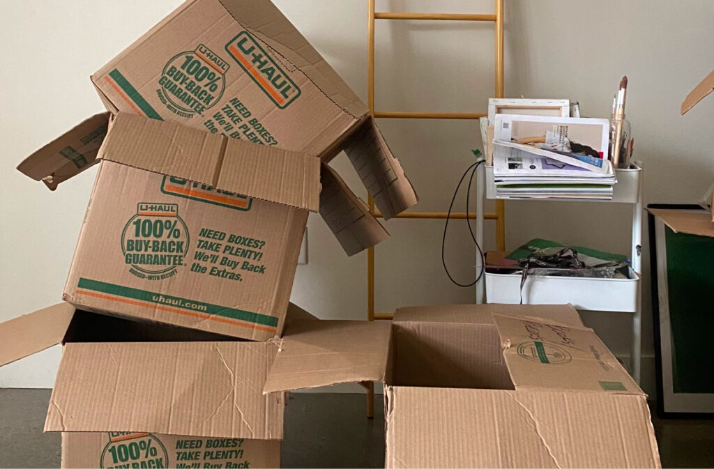 A pile of moving boxes in a new home